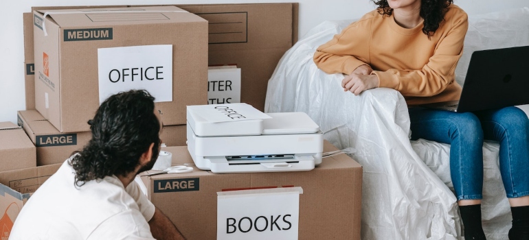 Picture of a couple trying to overcome the challenges of moving a home office to Burlington