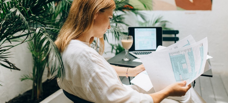 A woman reading moving contract so she can handle disputes with movers