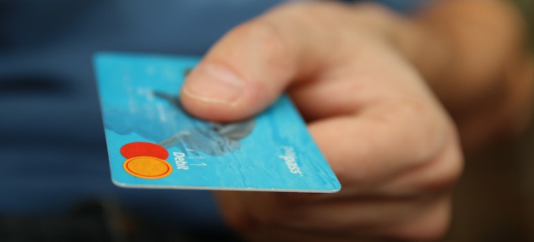 A man holding a debit card